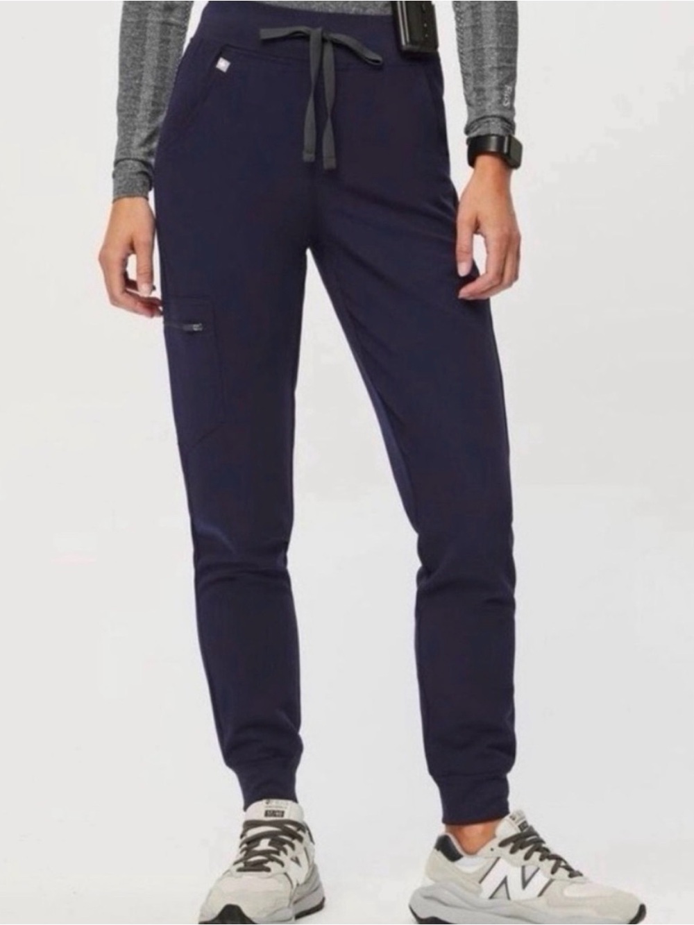 Women’s FIGS Zamora Jogger Scrub Pants in Navy Blue.